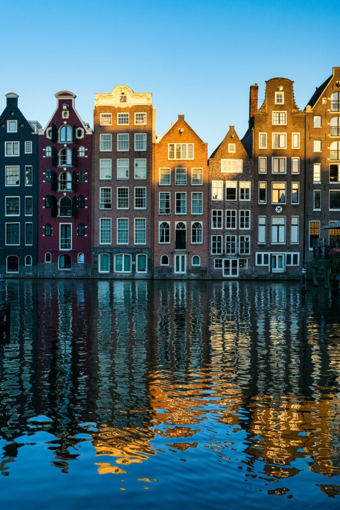 Charming Amsterdam Canal Houses Wallpaper: Colorful Facades Reflection