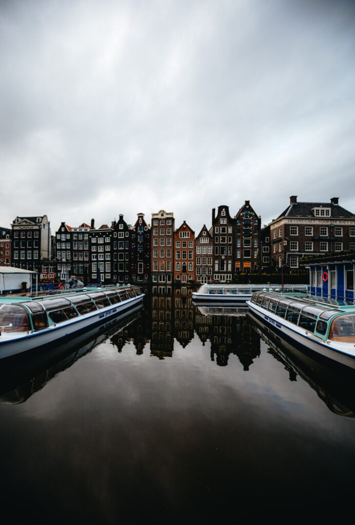 Charming Amsterdam Cityscape Wallpaper: Historic Buildings & Boats