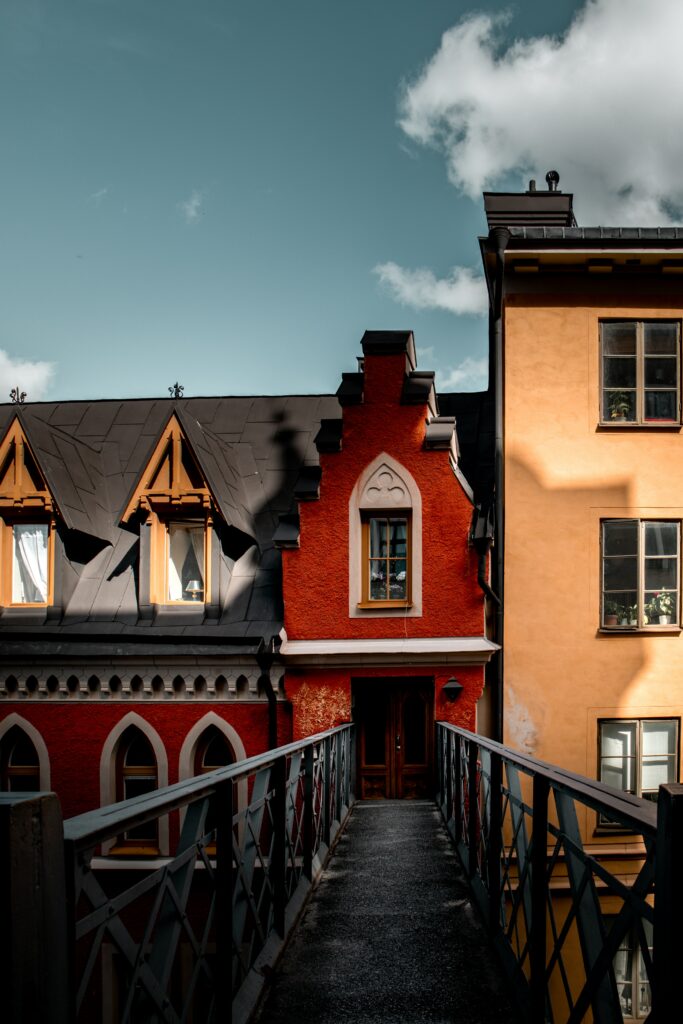 Charming Red & Yellow Building Wallpaper with Bridge & Blue Sky