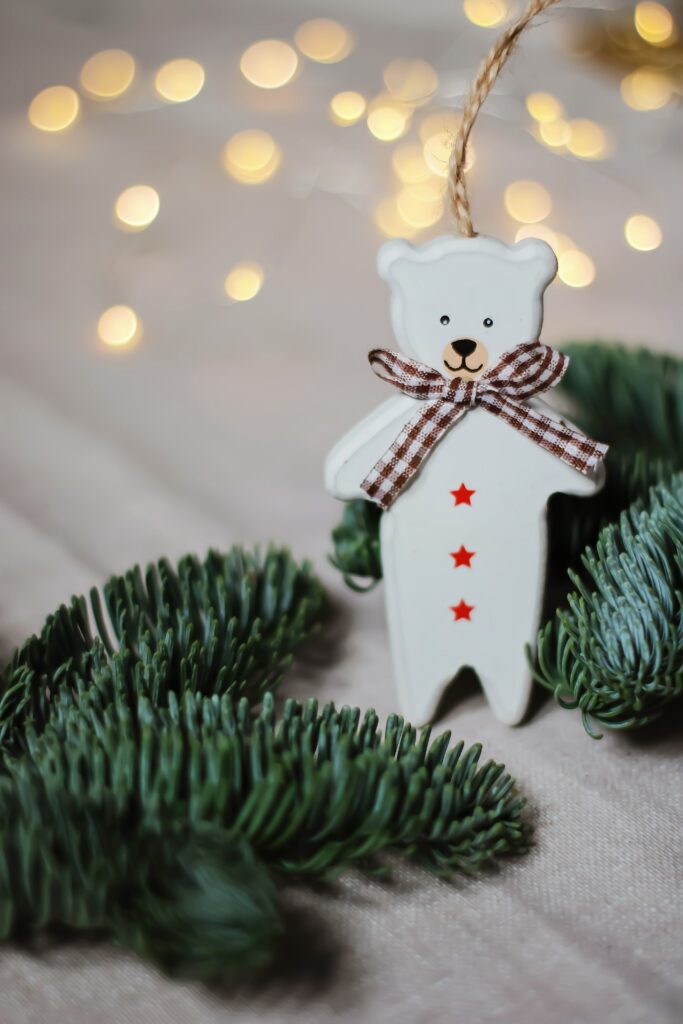 Charming Bear Ornament with Plaid Bow - Festive Holiday Wallpaper