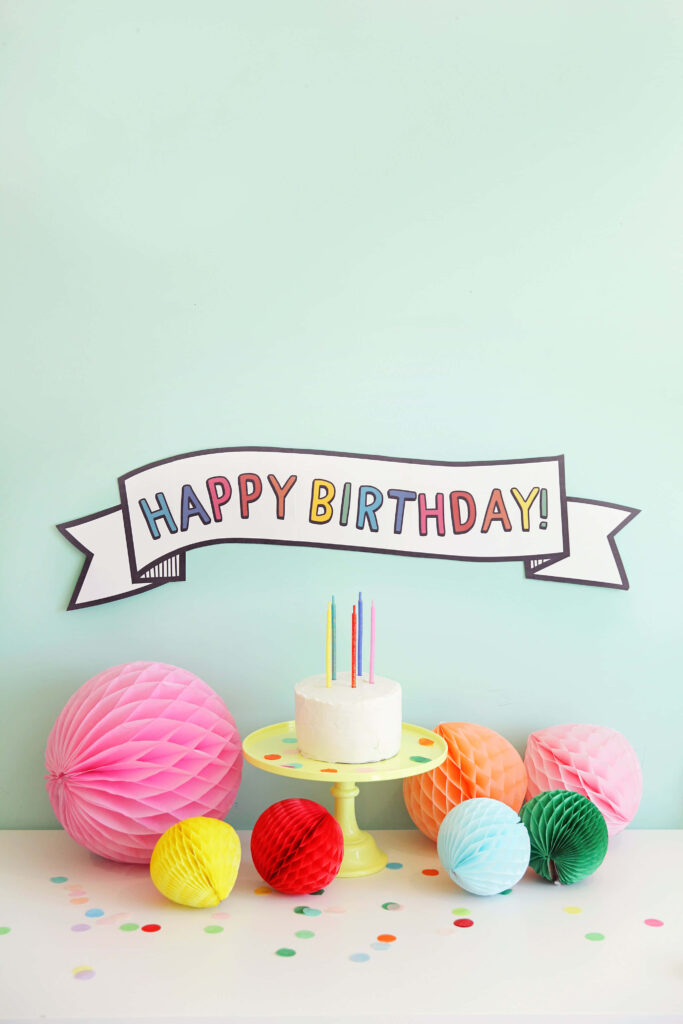Charming Birthday Setup: Colorful Cake & Festive Decorations Wallpaper