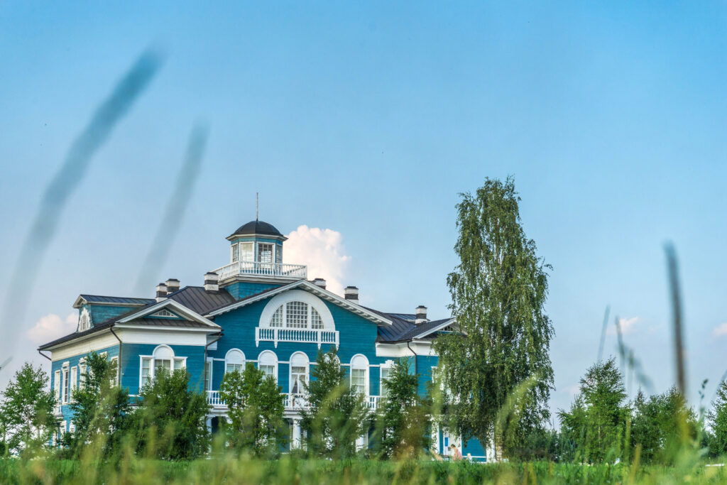 Charming Blue Cottage Wallpaper: Serene Summer Landscape Background