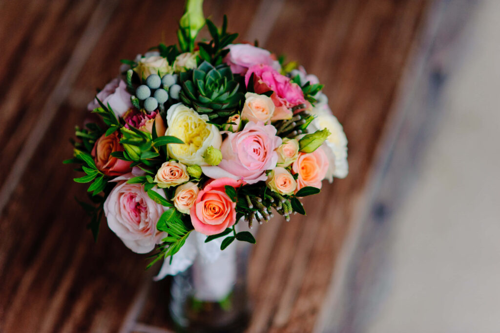 Charming Rose and Succulents Bouquet in Rustic Wooden Vase Wallpaper
