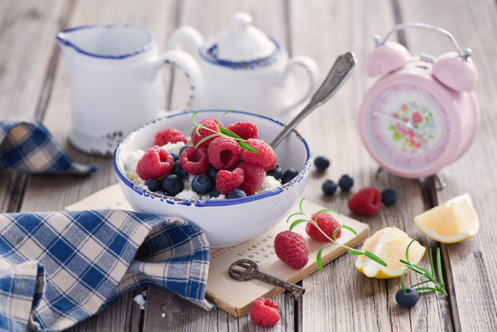 Charming Breakfast Scene: Raspberries, Blueberries, Cheese & Rustic Decor Wallpaper