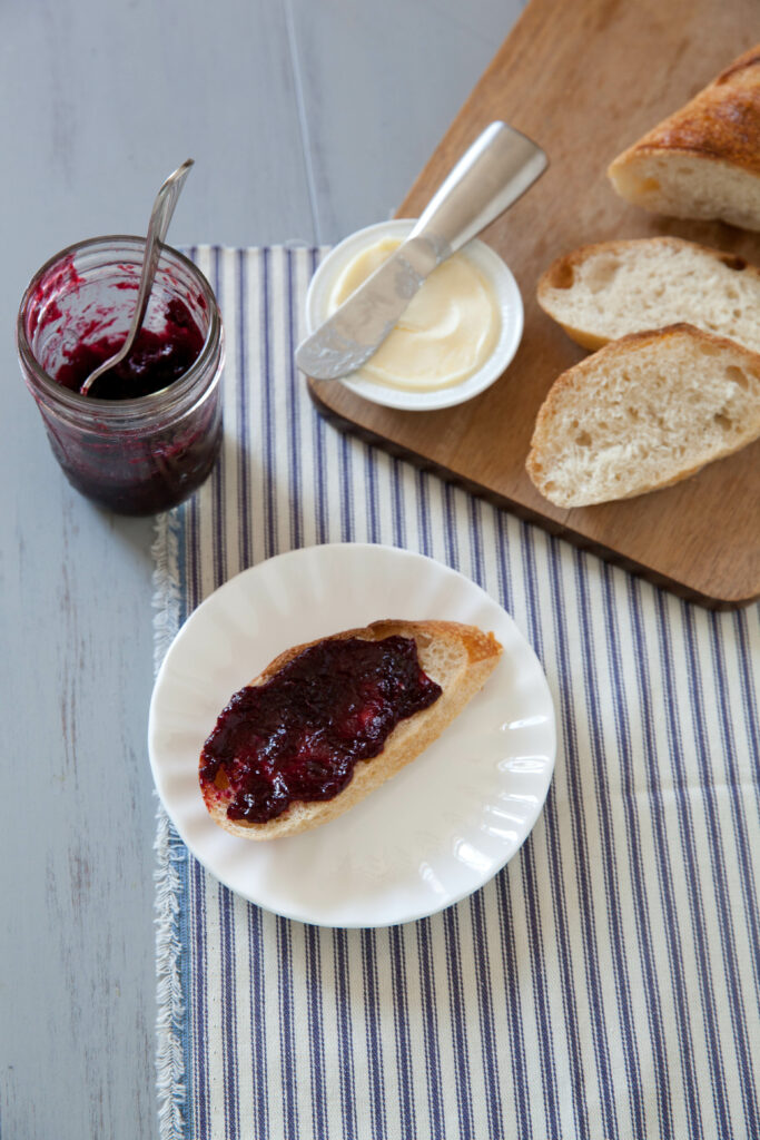 Charming Breakfast: Bread with Jam & Butter on Wooden Board Wallpaper
