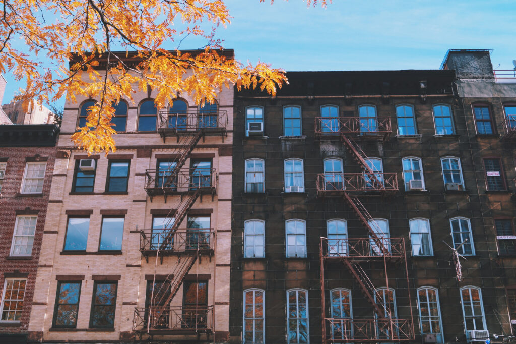 Charming Brick and Stone Building Wallpaper with Autumn Tree