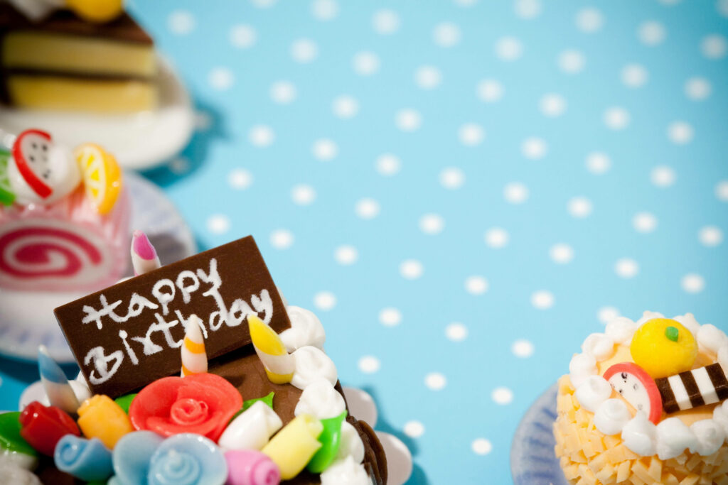 Charming Cake Wallpaper: Joyful Polka-Dotted Celebration Background