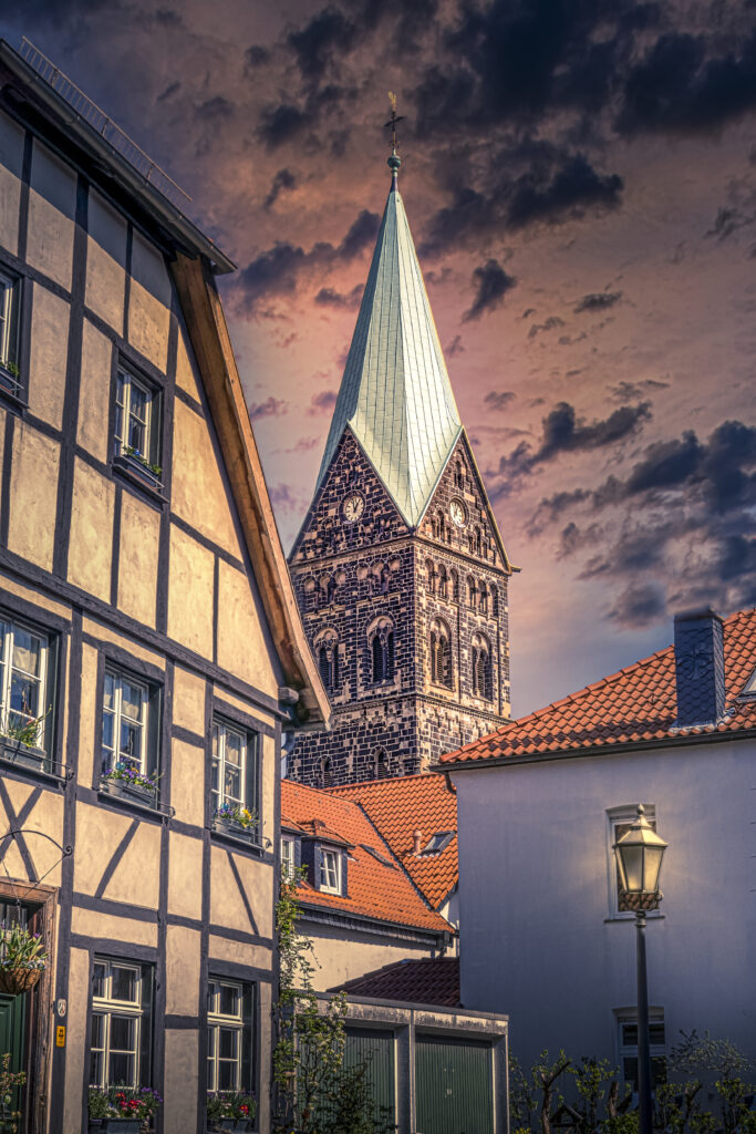 Charming Chapel Tower & Half-Timbered Homes - Serene Wallpaper Background