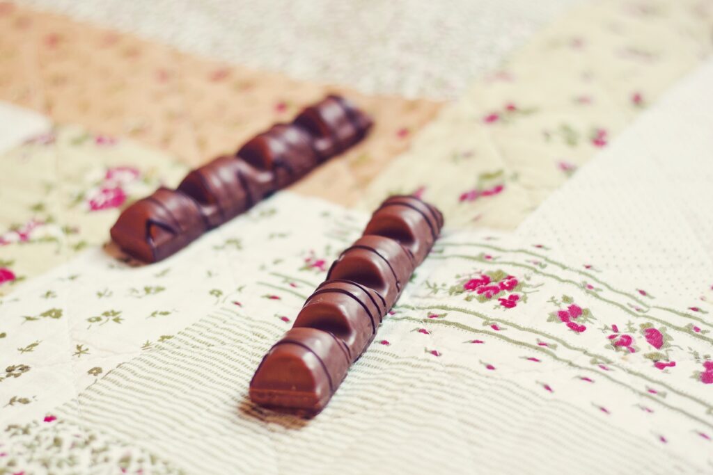 Cozy Chocolate Sticks Wallpaper: Sweet Ambiance on Patterned Cloth