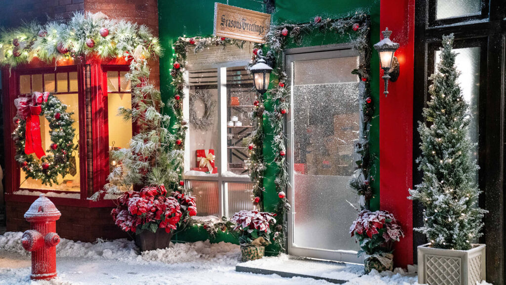 Charming Snowy Storefront: Festive Holiday Decor & Cozy Winter Scene Wallpaper