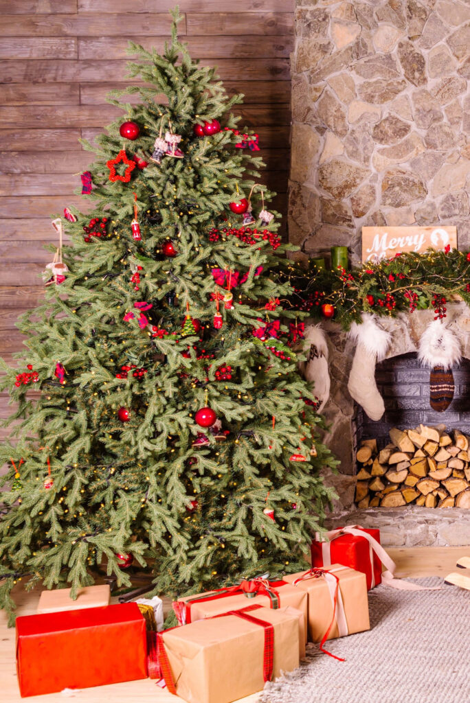 Cozy Christmas Tree with Sparkling Ornaments & Festive Fireplace Wallpaper