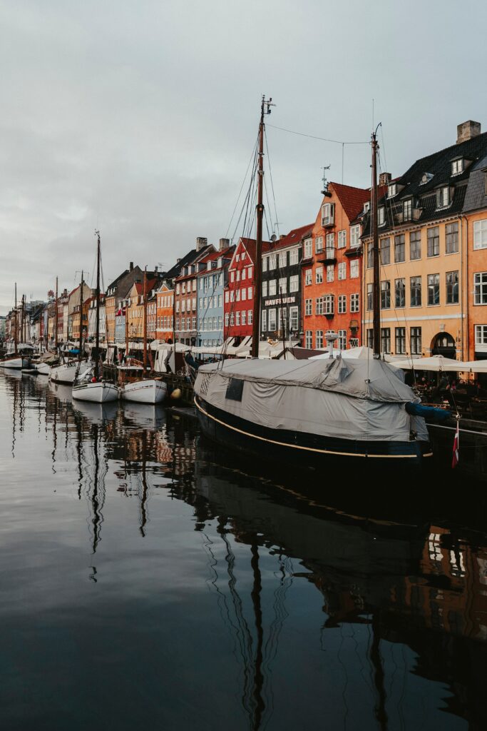 Charming Cityscape Wallpaper: Colorful Canal with Docked Boats
