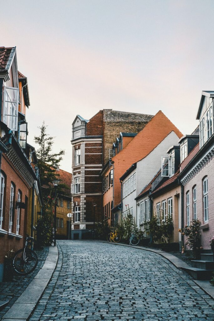Charming Cobblestone Street Wallpaper: Colorful Buildings at Sunset