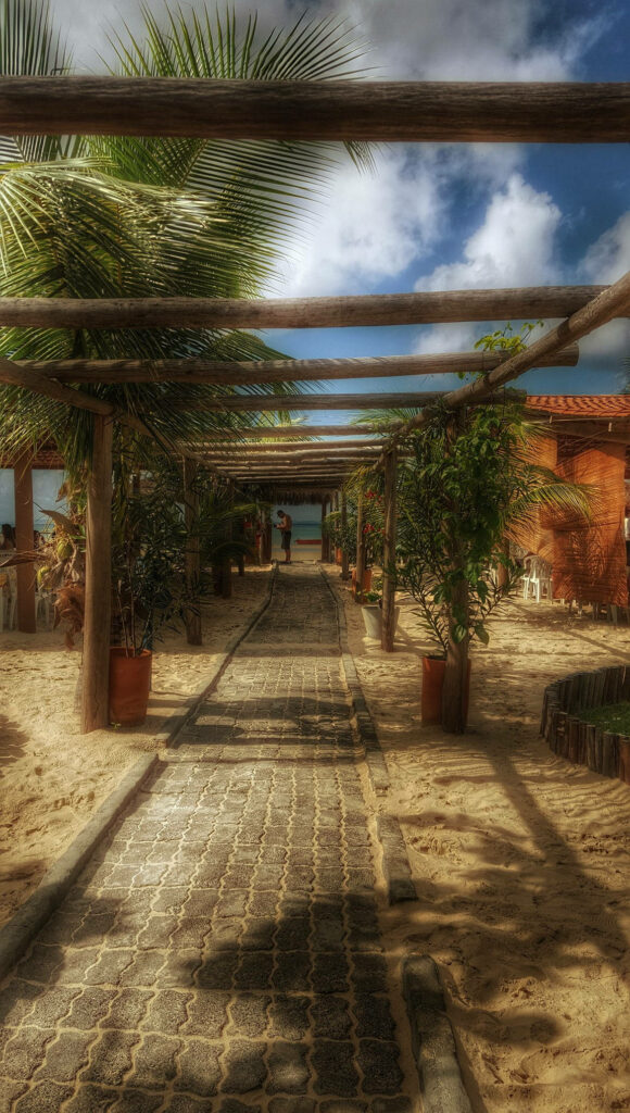 Charming Cobblestone Walkway to Serene Beach - 4K iPhone Wallpaper