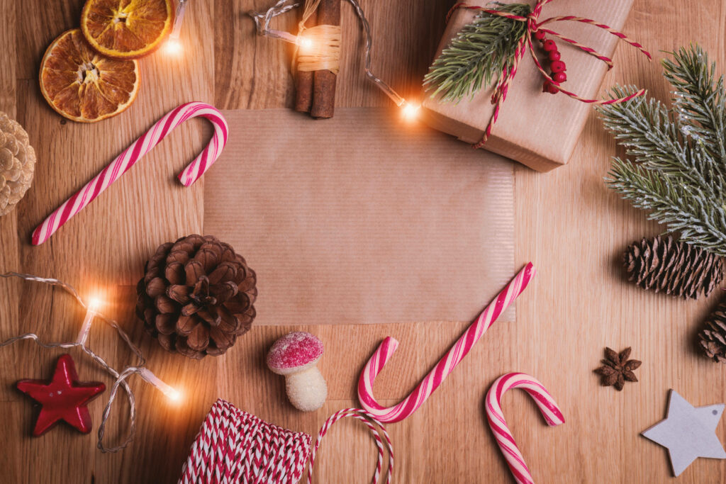 Festive Holiday Arrangement: Delightful Christmas Décor Captured on a Warm Wooden Setting Wallpaper
