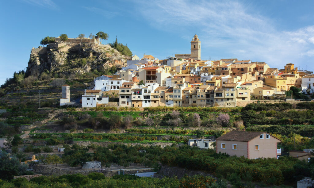 Charming Hillside Town Wallpaper: Scenic Countryside View Background