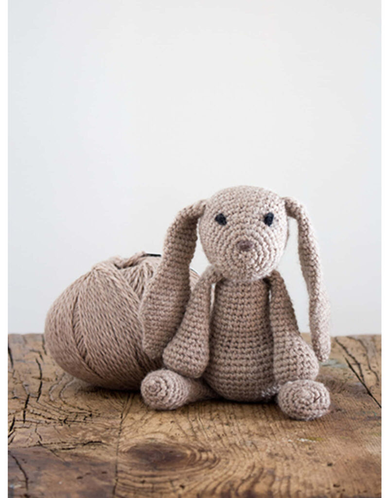 Charming Handmade Crochet Bunny Wallpaper on Rustic Wood