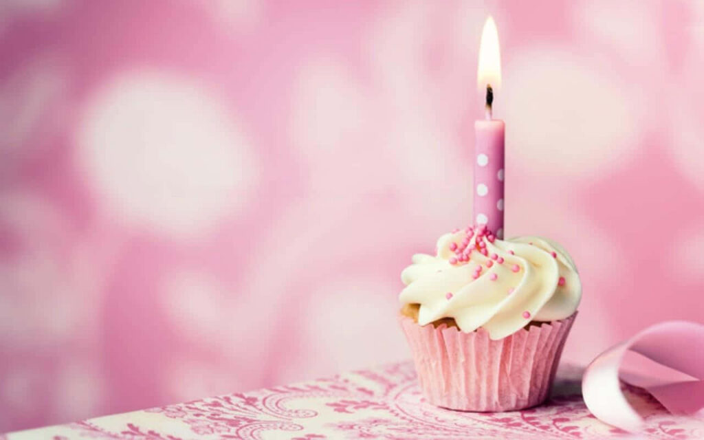 Festive Cupcake with Creamy Frosting, Sprinkles & Candle Delight Wallpaper
