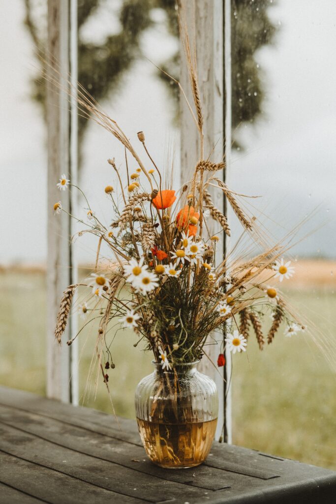 Elegant Bouquet of Daisies & Poppies in Rustic Glass Vase Wallpaper