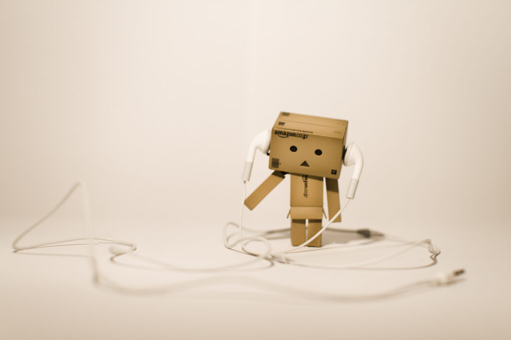 Danbo Wallpaper: Charming Cardboard Robot with Headphones on White