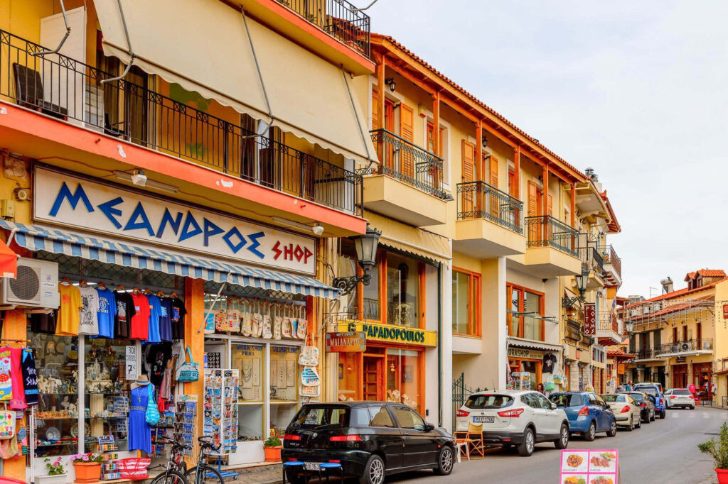 Charming Delphi Street: Vibrant Shops & Colorful Balconies Wallpaper
