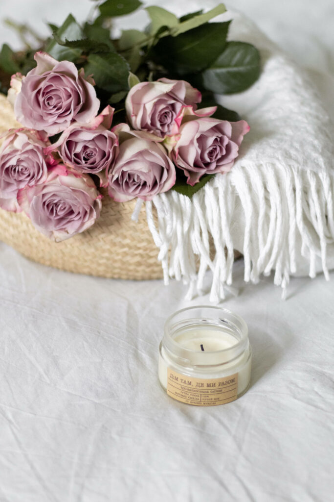 Charming Lavender Rose Bouquet with Cozy Blanket & Candle Background Wallpaper