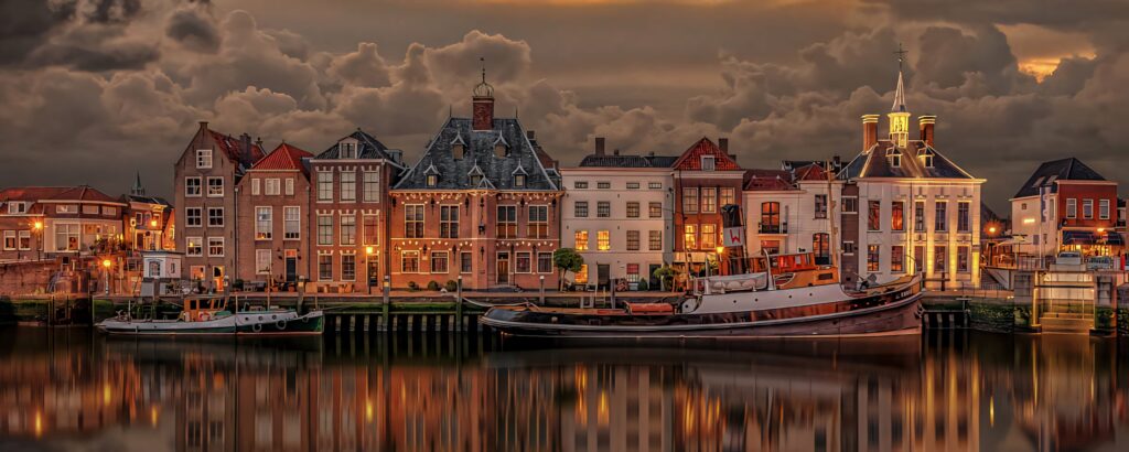 Charming Dutch Houses by the Waterfront: Captivating Wallpaper Background
