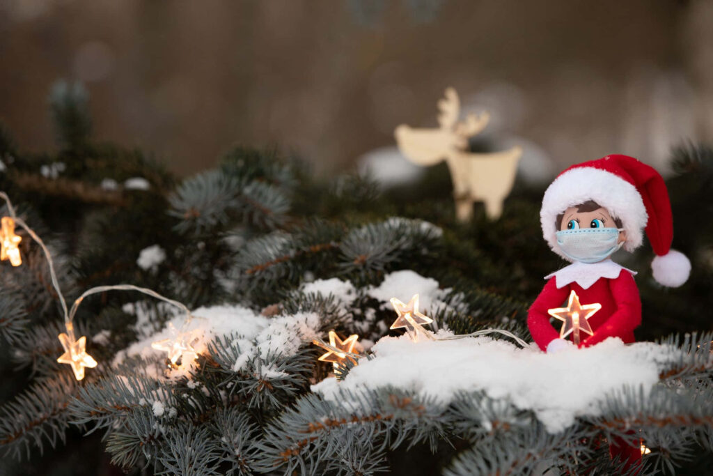 Charming Elf Wallpaper: Festive Snowy Scene with Lights & Reindeer