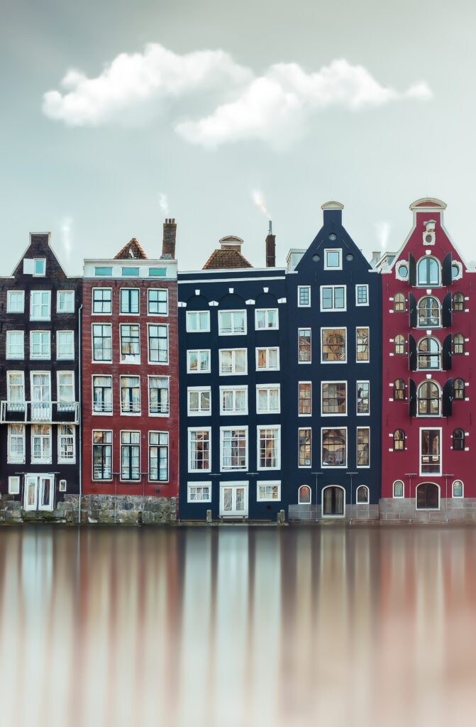 Charming European Buildings Reflected in Serene River Wallpaper