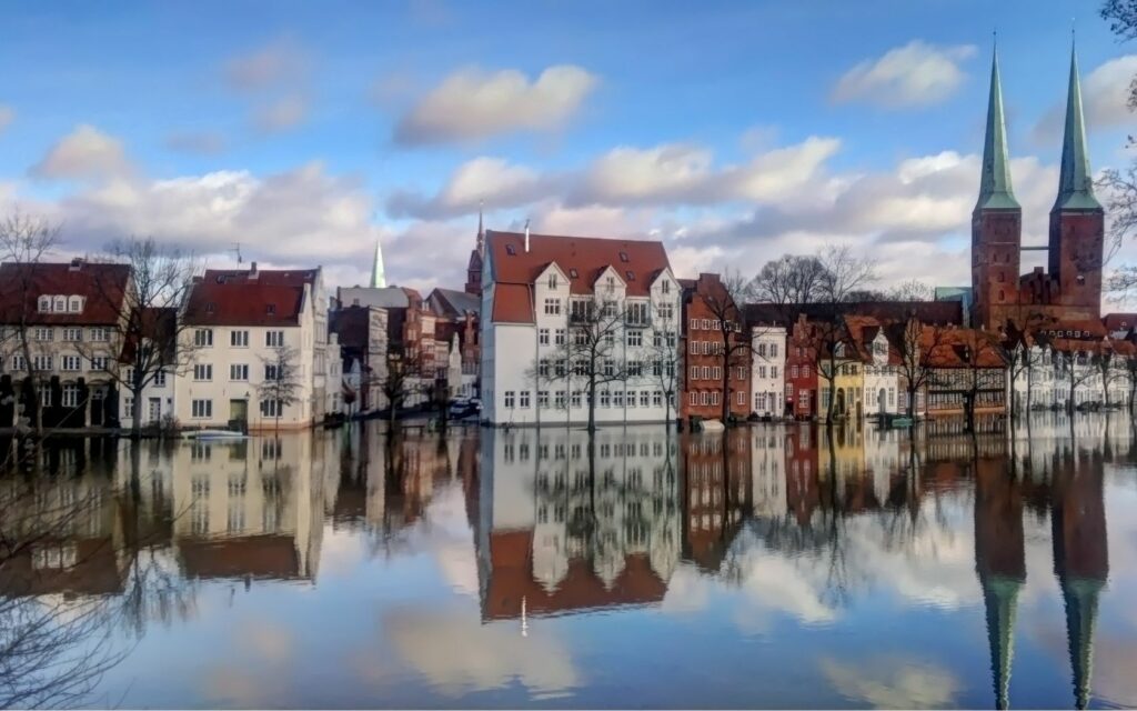 Charming European Townscape Wallpaper: Serene Water Reflection