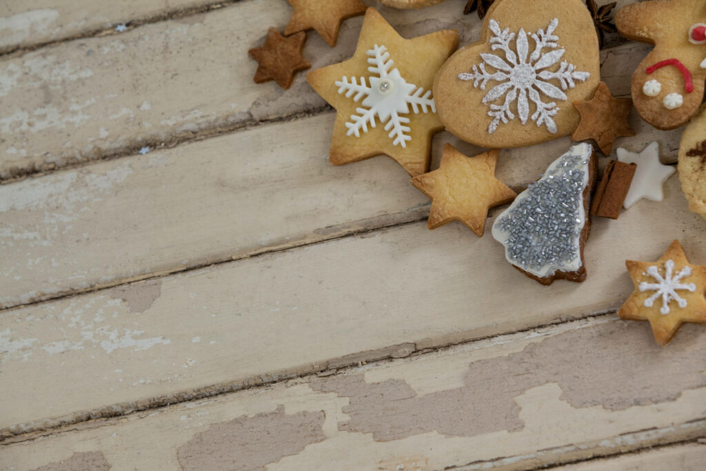 Festive Christmas Cookies on Rustic Wooden Background Wallpaper
