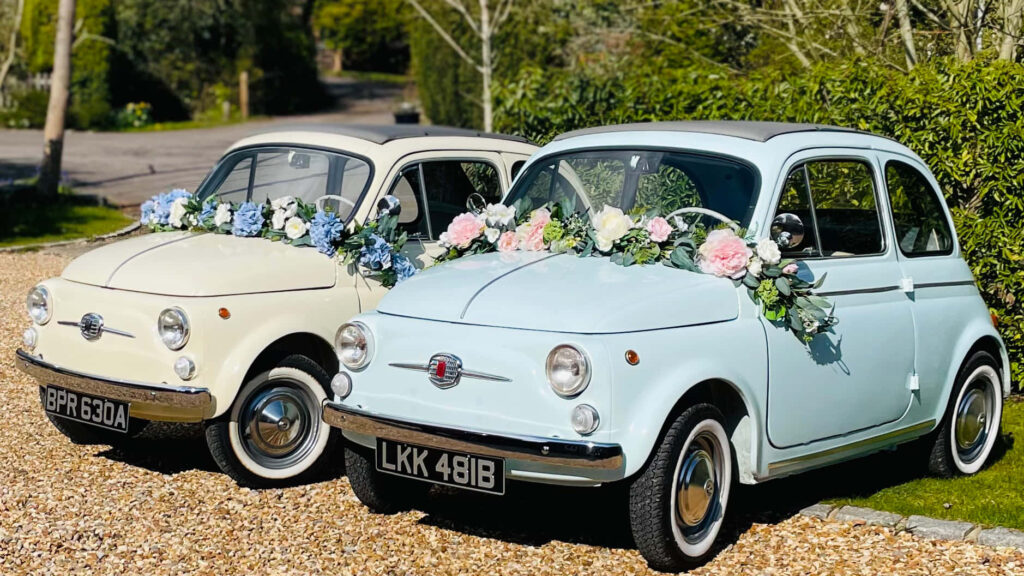 Elegant Fiat 500 Wallpaper: Floral Cars in Scenic Driveway Setting