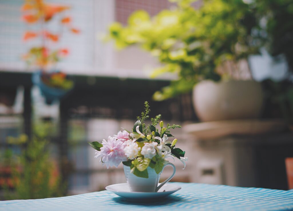 Charming Cup with Flowers - Serene Greenery Wallpaper Decor