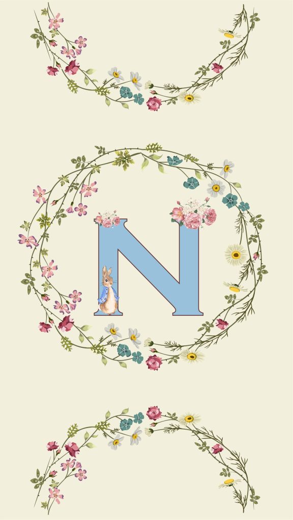 Light blue letter N with flowers and Peter Rabbit in pink floral wreath on cream background wallpaper