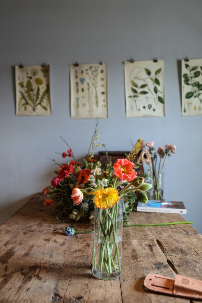 Charming Floral Bouquet Wallpaper with Rustic Table & Botanical Art