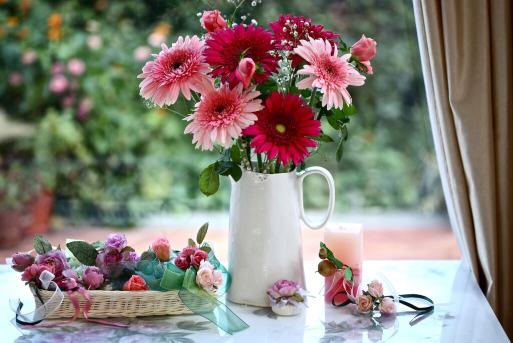 Charming Floral Wallpaper: Vibrant Gerberas & Roses in Serene Setting
