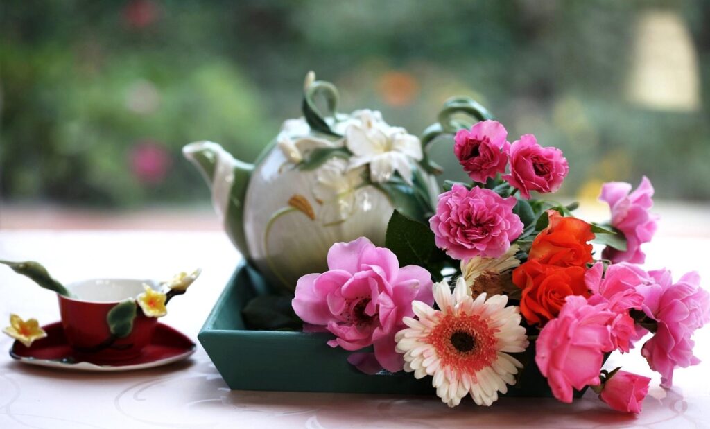 Vibrant Floral Wallpaper with Gerberas, Roses, and Teapot Background