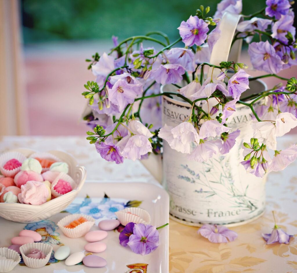 Charming Floral Wallpaper with Purple Flowers and Pastel Treats