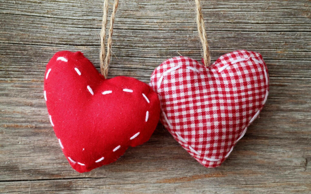 Charming Heart-Shaped Pillow Wallpaper with Rustic Wood Background