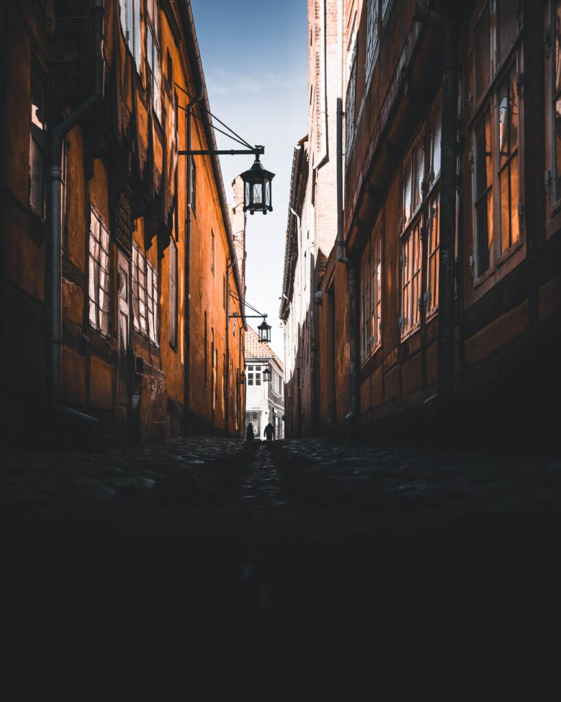 Charming Historic Alleyway Wallpaper with Weathered Buildings