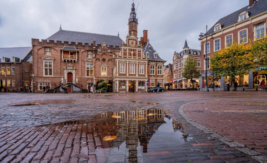 Charming Dutch Historic Square: Cobblestone & Reflection Wallpaper