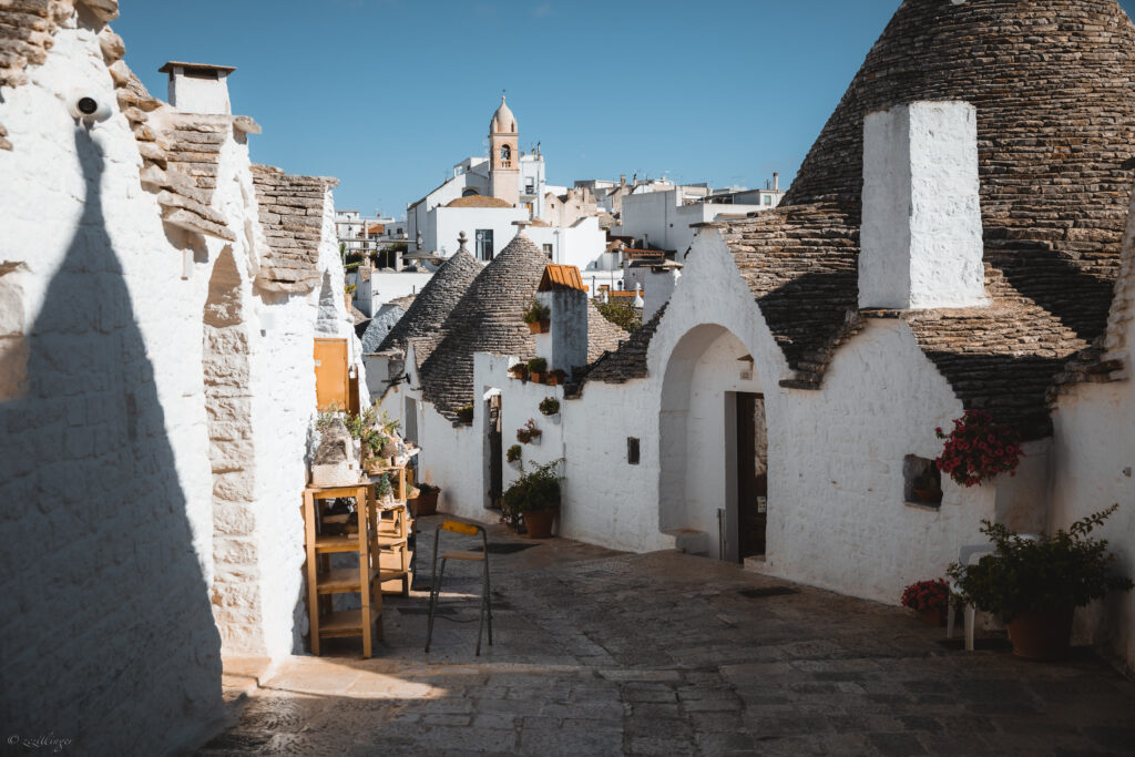 Charming Street Wallpaper: Whitewashed Houses & Vibrant Flowers