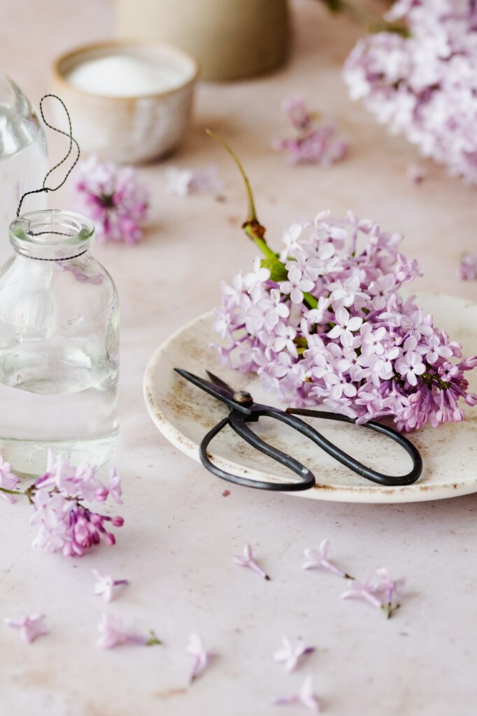 Delicate Lilac Flowers on Neutral Background with Antique Scissors Wallpaper