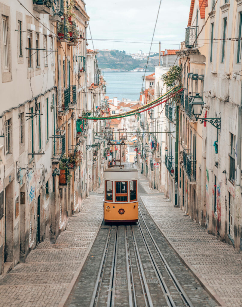 Charming Lisbon Tram Wallpaper: Vintage Streets & Waterfront View