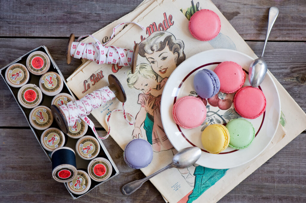 Charming Vintage Wallpaper: Colorful Macarons & Cookies on Rustic Table