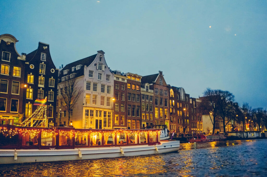 Charming Canal Evening in Netherlands - Illuminated Boat Wallpaper