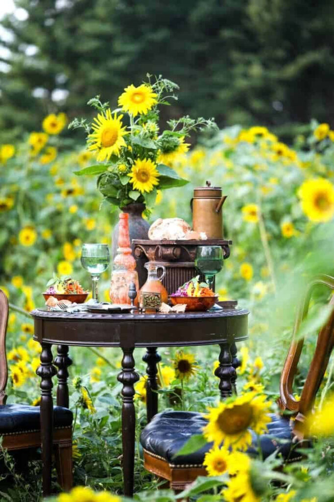 Charming Outdoor Rustic Table Set in Vibrant Sunflower Field Wallpaper