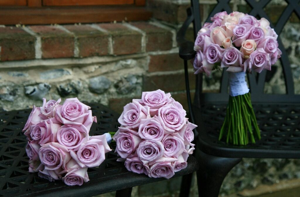 Charming Pale Pink Rose Bouquets on Wrought Iron Bench Background Wallpaper