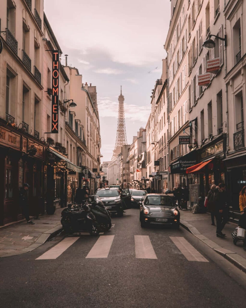 Charming Parisian Street Scene Wallpaper with Eiffel Tower Background