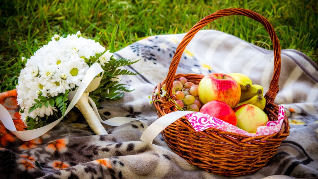 Charming Picnic Scene Wallpaper with Wicker Basket and Flowers